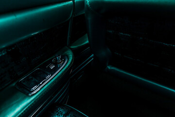 Classic American car with a green vinyl interior showing the armrest