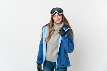 Skier girl with snowboarding glasses isolated on white background surprised and pointing front