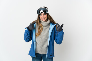 Skier girl with snowboarding glasses isolated on white background giving a thumbs up gesture