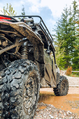 UTV in the woods dirty from mud © Brandon Woyshnis