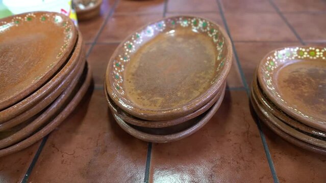 towers of hand-painted typical Mexican clay dishes ready to serve typical food in a restaurant, concept of handmade Mexican crafts