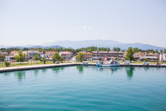 Panoramic view of Keramoti, small town, and port in Greece. Seascape. Beautiful blue water and sky. Summer day. Travel holiday vacation. 