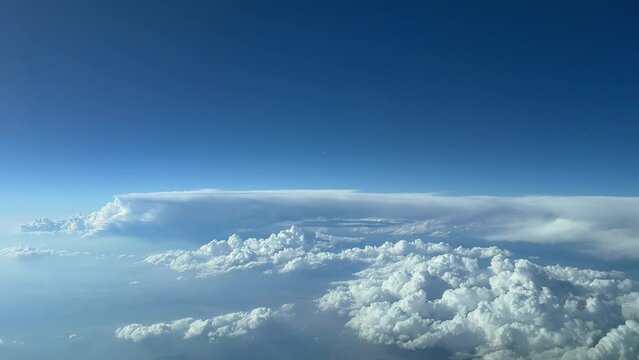 Aerial view from a cockpit jet flying at 12000 metres tigh toward a stormy and bad weather aera, 4K, 60 FPS.