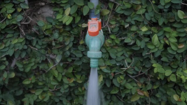 A man opening Running tap
