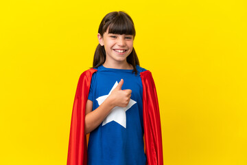 Little super hero kid isolated on purple background giving a thumbs up gesture