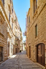 Narrow street in the historic center of Molfetta, a village in the Puglia region, Italy