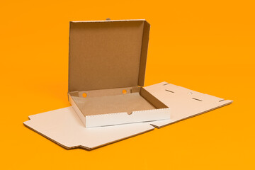 an empty pizza box and a disassembled box lie on a colored background