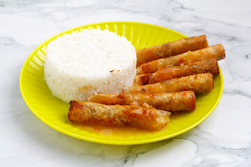 Freshly cooked Filipino food called Lumpiang Shanghai with rice