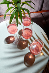 Cold alcoholic or non-alcoholic cocktail on pastel background. Hard light, deep shadow.