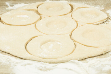 Dough rolled out on the table in the form of cakes