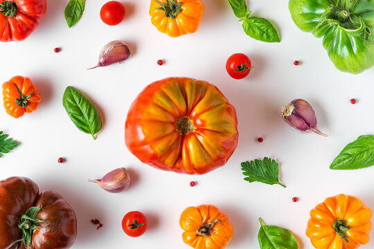 Food composition. Tomatoes, basil, garlic and pepper isolated on white background. Flat lay. Top view