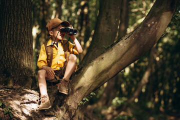 Boyscout travelling in the woods investigating nature