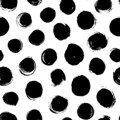 Black and white pattern with bold circles. Seamless ornament with grunge brush circles. Polka dot motif wallpaper. Abstract pattern of bold black shabby dots or spots on white. Hand drawn stains