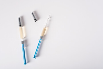 Two syringes with medicine for injection on a white background.