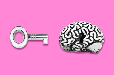 Brain and master key isolated on pink background