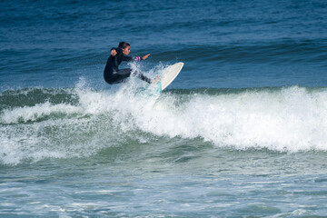 Surfer girl riding a wave