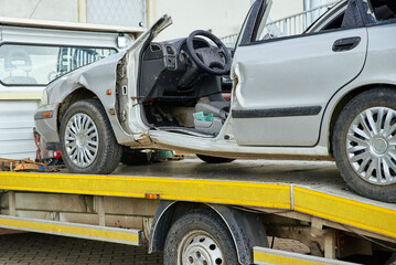 Wrecked car loading on tow truck after crash traffic accident, Concept of dangerous driving after...