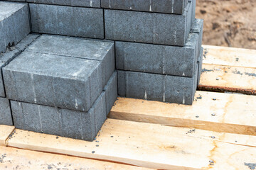 Storage of paving slabs on pallets at the construction site. Ready-to-install concrete paving slabs. Finished products warehouse.