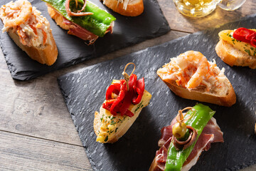 Assortment of Spanish pintxos on wooden table	