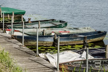 Fototapeten old rowing boats at a quai in river Oude IJssel near the little village of Hoog Keppel in summer © henkbouwers
