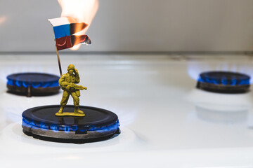 Russian soldier holds a burning flag. Gas issue and economics. Russian flag