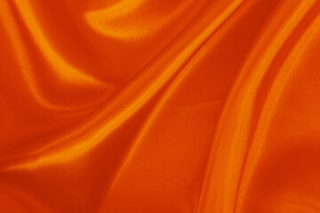 Orange fabric texture background, detail of silk or linen pattern.