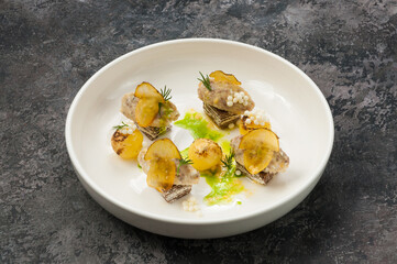 dish with minced fish, potato balls and mushrooms in the restaurant