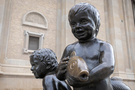 ZARAGOZA, SPAIN-MAY 15, 2021: Bronze statue of a boy with a fish - fontain on Plaza del Pillar