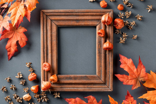 Autumn leaves are red and orange. composition with picture frame. copy space, flat lay