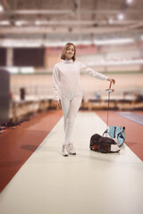 fenser in a white  uniform is training to participate in  a duel