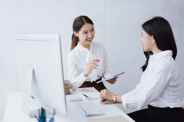 Fototapeta premium Happy young business women are discussed and working on laptop in office space.