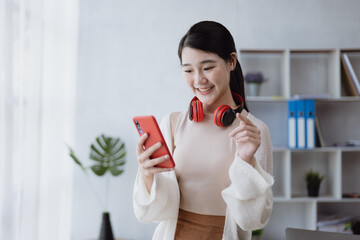 Young beautiful woman has a chatting conversation on smartphone at home.