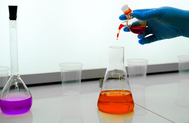A laboratory assistant performs a chemical analysis of water for mechanical impurities