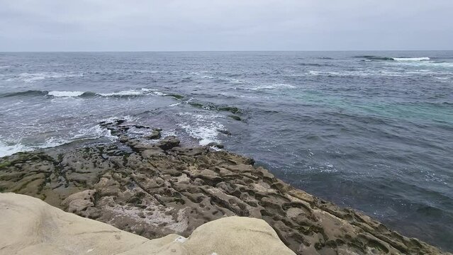 La jolla rock pattern with potholes at the shore
