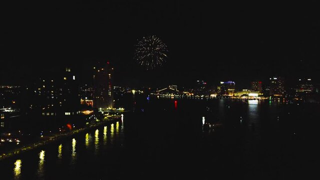An aerial moving toward the incredible display of very colorful fireworks at Norfolk, Virginia on July 4th.   A celebration to honor the founding of the United States of America