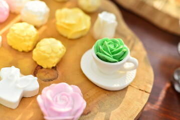 white mini cup decorated with handmade soap, green flower soap
