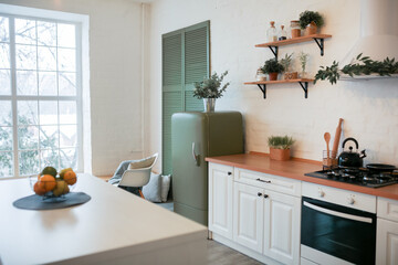 Modern Kitchen Interior with Island, Sink, Cabinets, and Big Window in New Luxury Home.