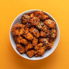 Fried Seasoned Chicken, Sesame Seeds, Sticky BBQ, Burger, Curly Fries, Chopsticks, Asian Style, Korean, Chinese Food Photography Yellow Backdrop