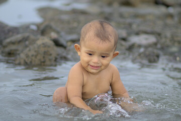 Rhan Rohingya boy child is playing in water