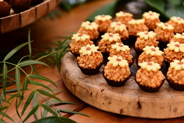 sweets decorated with flowers on party table, candy store, condensed milk candy balls, candy balls