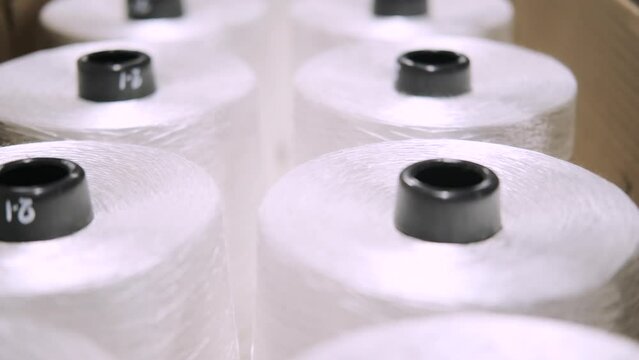 production of fiberglass yarn. Finished fiberglass spools are awaiting inspection and packaging. fiberglass spools ready for sale