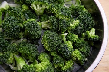 Closeup of broccoli in a metallic dish ready to be cooked