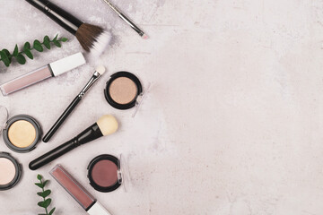 A collection of make-up tools scattered on the textured background.Various tools for visage, for...