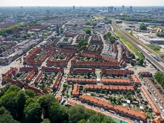 Aerial shot of a compact mid rise city under a blue sky with white puffy clouds