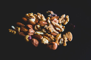 pine cones and nuts on black background