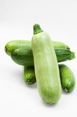 fresh zucchini on a white background. delicious green vegetables on the table. appetizing zucchini on a light texture. healthy food concept