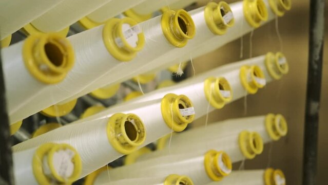 production of fiberglass yarn. Finished fiberglass spools are awaiting inspection and packaging. fiberglass spools ready for sale