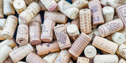 Wine corks pile full frame natural background closeup. Wine corks as background. Flatlay view.