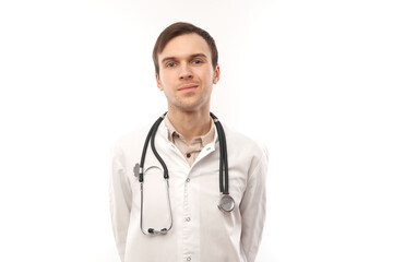 Fototapeta premium Portrait of handsome doctor in white medical coat with stethoscope on white background with copy space
