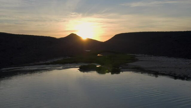 Aerial view of the mountains gleaming under the sunset in the Espiritu Santo Island in 4K
